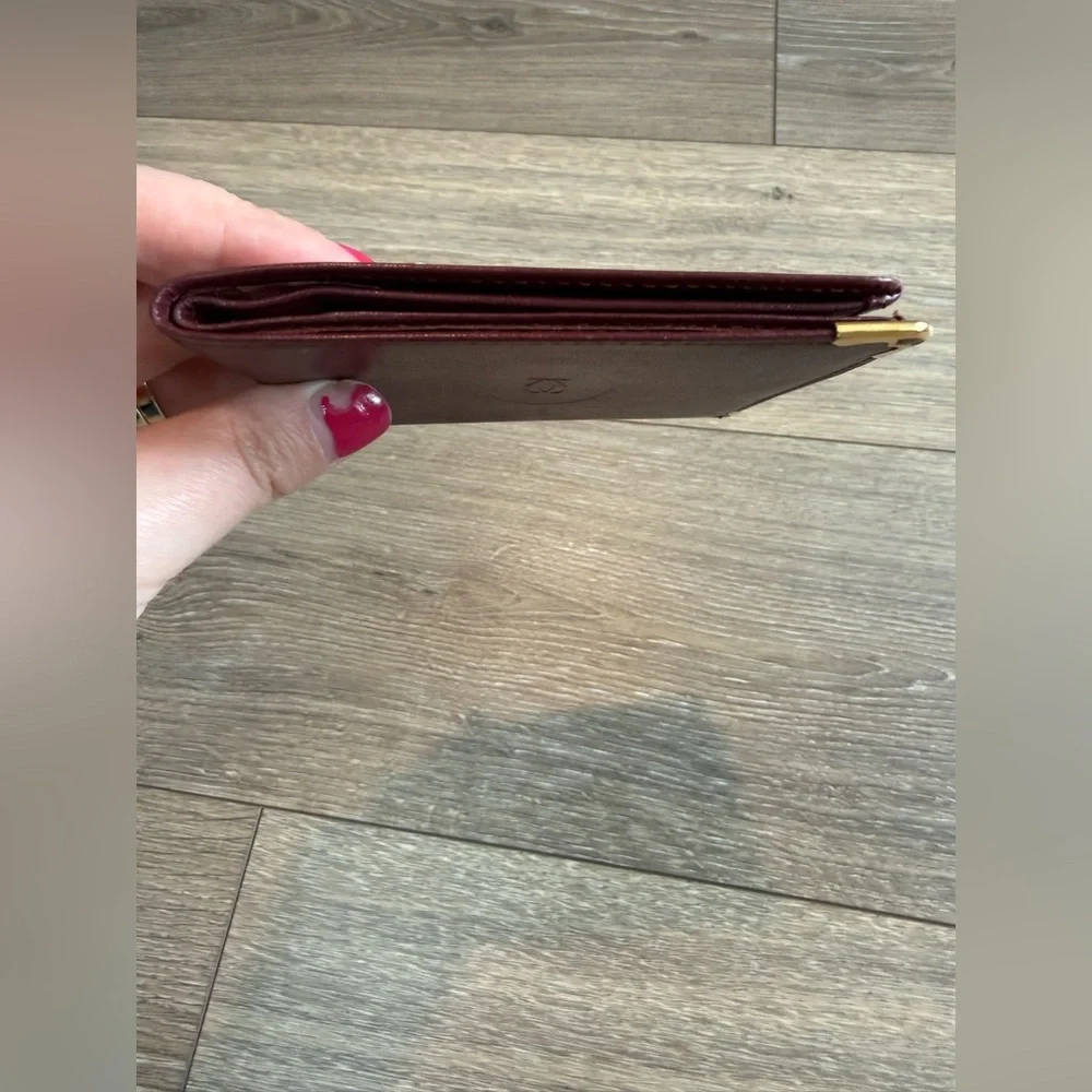 Cartier Men’s Deep Red Leather Bifold with Gold Corners